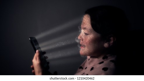 Young Child Using A Smart Phone With Facial Recognition Technology With 3D Face Mapping