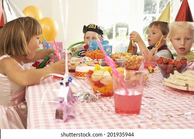 Young Children Eating At Birthday Party