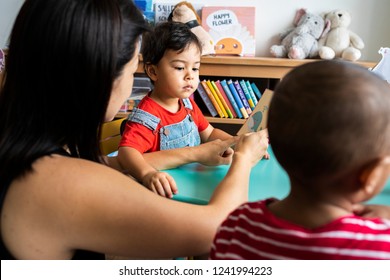 Young children learning the English alphabet with their parents