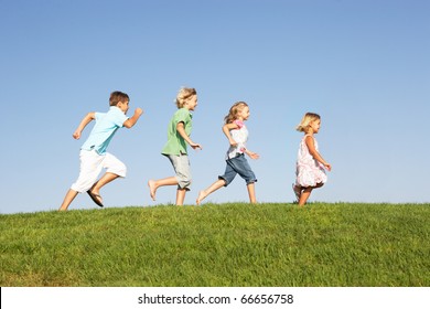 Young Children Running Through Field