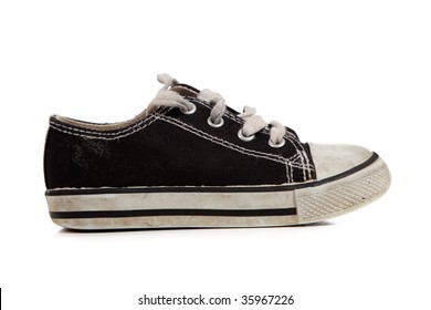 A Young Child's Tennis Shoes On A White Background With Copy Space