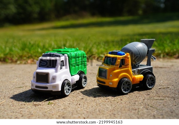 Young child\'s toy\
truck set sitting\
outside.