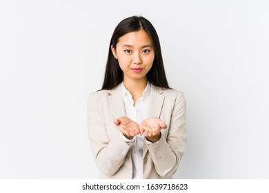 Young Chinese Business Woman Isolated Holding Something With Palms, Offering To Camera.