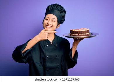 Young Chinese Chef Woman Wearing Cooker Uniform And Hat Holding Tray With Cake Very Happy Pointing With Hand And Finger