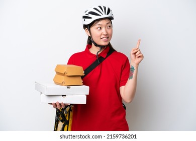 Young Chinese Delivery Woman Taking Takeaway Food Isolated On White Background Pointing Up A Great Idea