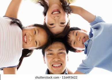 Young Chinese Family Looking Down Into Camera