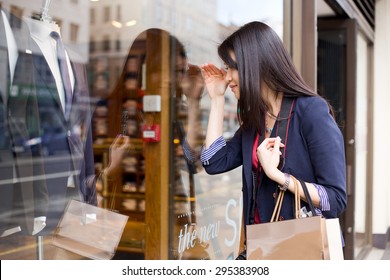 Young Chinese Girl Looking In A Shop Window