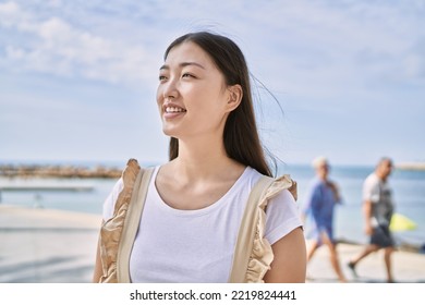 Young Chinese Girl Smiling Happy Standing At The Beach.