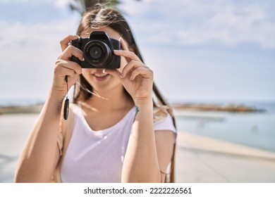 Young Chinese Girl Smiling Happy Using Camera At The Promenade.