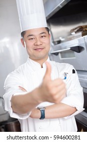 Young Chinese Man Chef In Modern Kitchen