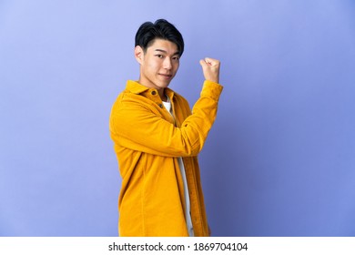 Young Chinese Man Isolated On Purple Background Doing Strong Gesture