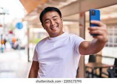 Young Chinese Man Smiling Confident Making Selfie By The Smartphone At Street