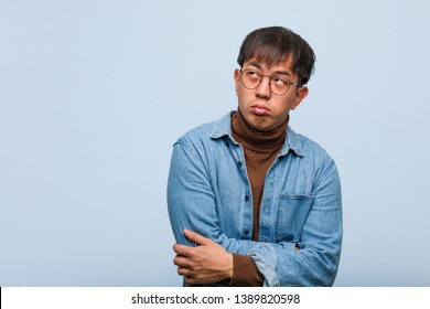 Young Chinese Man Tired And Bored