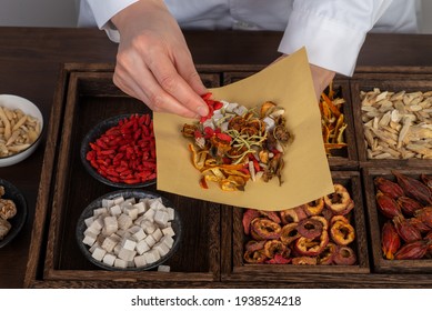 Young Chinese medicine is preparing Chinese herbal medicine - Shutterstock ID 1938524218