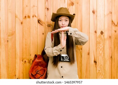 Young Chinese Traveler Woman Showing A Timeout Gesture.