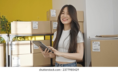 Young chinese woman ecommerce business worker using touchpad at office - Powered by Shutterstock