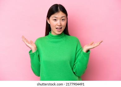 Young Chinese Woman Isolated On Pink Background With Shocked Facial Expression