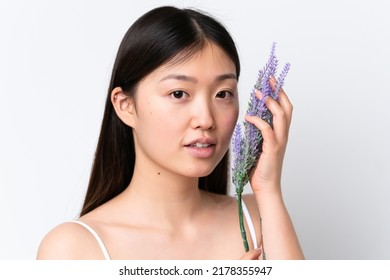 Young Chinese Woman Isolated On White Background Holding A Lavender Plant. Close Up Portrait