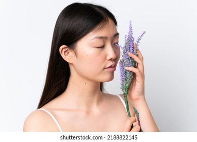 Young Chinese Woman Isolated On White Background Holding A Lavender Plant. Close Up Portrait