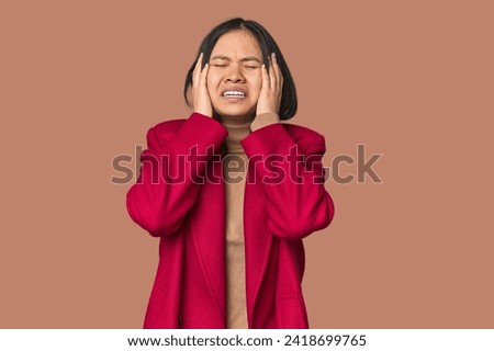 Young chinese woman isolated whining and crying disconsolately.