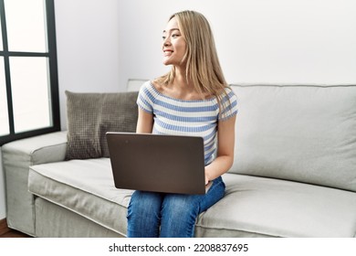 Young Chinese Woman Smiling Confident Using Laptop At Home