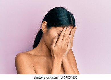 Young Chinese Woman Standing Topless Showing Skin With Sad Expression Covering Face With Hands While Crying. Depression Concept. 