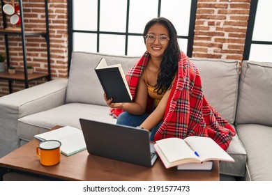 Young Chinese Woman Studying Sitting On Sofa At Home