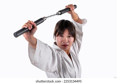 Young Chinese woman, using the nunchaku, in her kun-fu exercises - Powered by Shutterstock