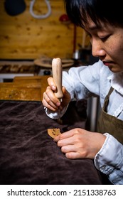 Young Chinese Woman Violin Maker Signs The Jumper Of Her Violin With Fire With Her Name In The Workshop