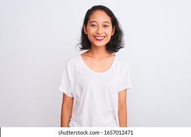 Young chinese woman wearing casual t-shirt standing over isolated white background with a happy and cool smile on face. Lucky person.
