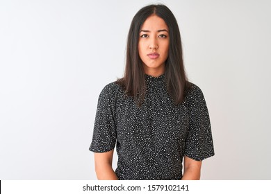 Young Chinese Woman Wearing Elegant T-shirt Standing Over Isolated White Background With Serious Expression On Face. Simple And Natural Looking At The Camera.