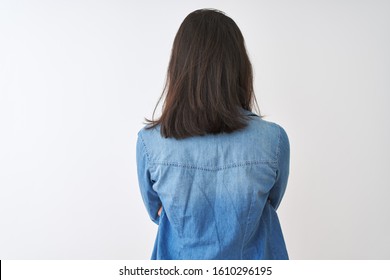 Young chinese woman wearing striped t-shirt and denim shirt over isolated white background standing backwards looking away with crossed arms - Powered by Shutterstock