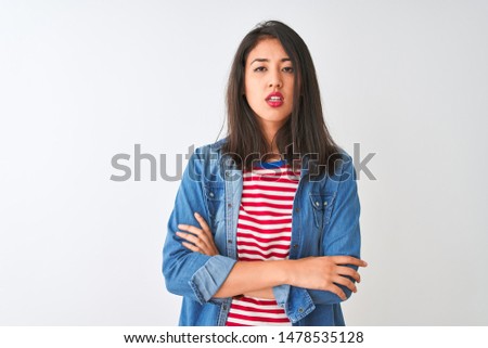 Young chinese woman wearing striped t-shirt and denim shirt over isolated white background looking sleepy and tired, exhausted for fatigue and hangover, lazy eyes in the morning.