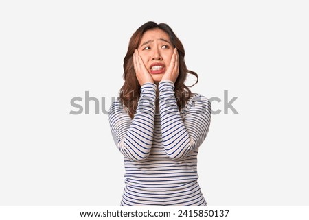 A young chinese woman whining and crying disconsolately.