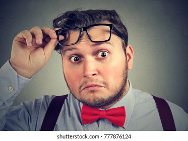 Young Chubby Man Taking Off Glasses And Looking At Camera With Big Surprise. 