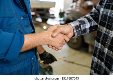 Young Client Of Contemporary Car Repair Service And Professional Technician Greeting One Another By Handshake