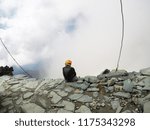 Young climber with a view of the clouds