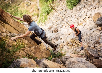 Young Climbers Rock Climbing In Old Quarry