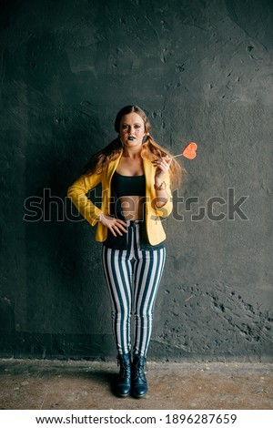 Young clown girl posing in studio