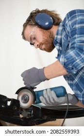 Young Coachbuilder Mechanic Using Grinder