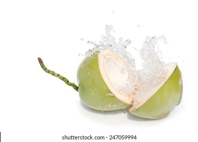 young coconut cut haft clear coconut juice  splashing. The pure white light Invited to enjoy a relaxing vacation at the summer time. I isolated on white background