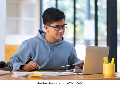 Young collage student using computer and mobile device studying online. Education and online learning. 