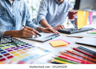 Young colleagues designers working together on a creative project and color samples for selection, Color swatch samples, Brainstorming Planning Partnership, creative graphic design working desktop. - Powered by Shutterstock