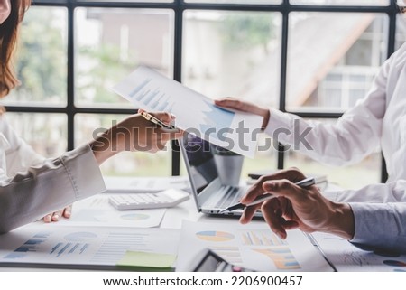 Young colleagues discuss business brainstorming and price charts analyze business people at the desk brilliantly in modern collaborative office teamwork ideas. Calculate personal tax for customers