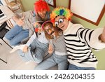 Young colleagues with funny disguise taking selfie in office. April Fools