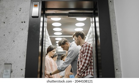 Young Colleagues Going Inside Elevator, Office Employees In Business Center