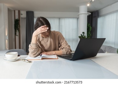 Young college student girl or freelance business woman having issue with her broken laptop. Female cant work on her old outdate computer and get frustrated and angry.