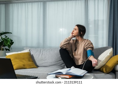 Young College Student Measures Blood Pressure At Home After Long And Stressful Study For Final Exam. Female Business Person With Small Company Got Sick After She Calculated Expenses And Financials.