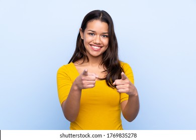 Young Colombian girl over isolated blue background points finger at you - Shutterstock ID 1769835278
