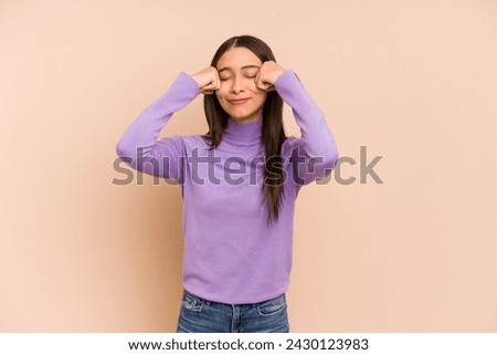 Young colombian woman isolated on beige background whining and crying disconsolately.